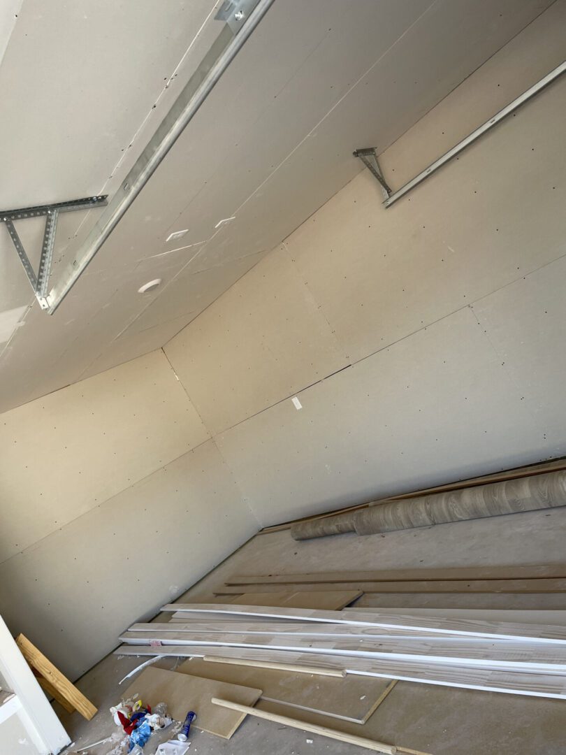 Garage interior under construction with materials.
