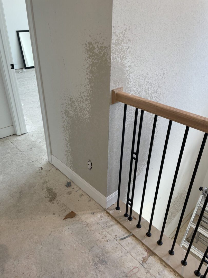 Staircase corner with unfinished wall and floor.