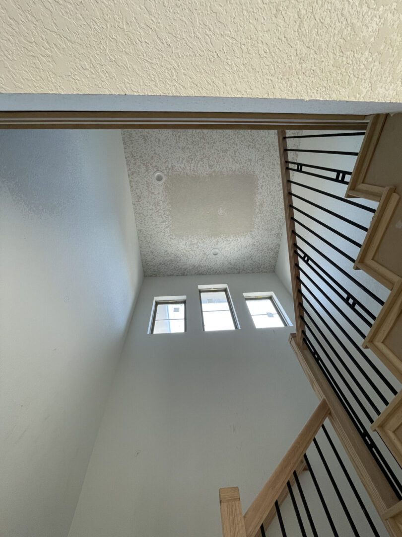 Staircase with three small windows above.