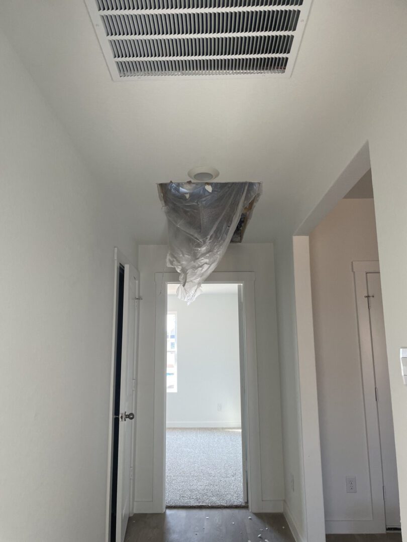 Hallway with ceiling repair in progress.