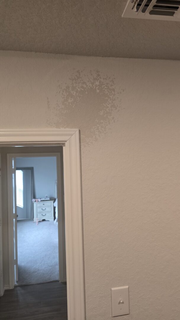 Wall with a water stain above door.