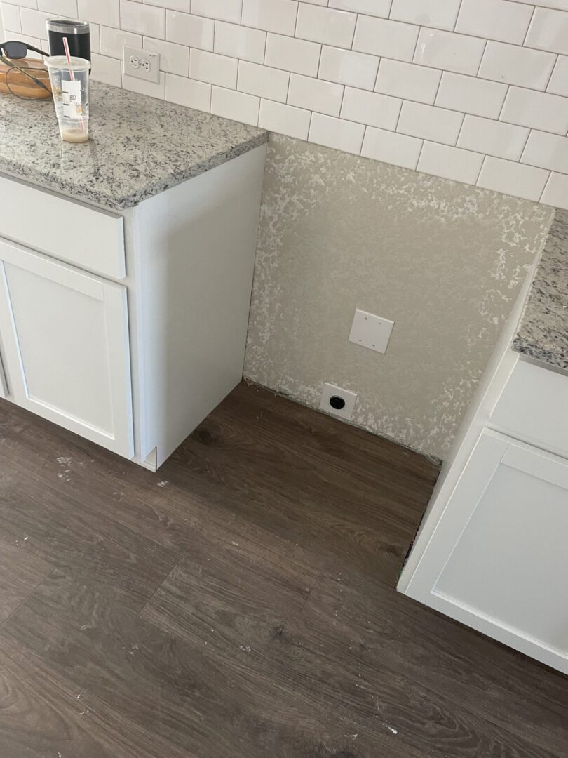Kitchen counter space with white cabinets.