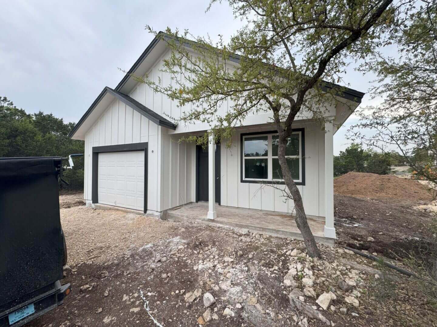 white house with a garage.